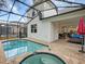 Enclosed pool and spa area with brick pavers and outdoor seating with nearby kitchen access at 8943 Coconut Breeze Dr, Kissimmee, FL 34747