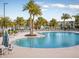 Beautiful community pool with comfortable seating and umbrellas for a resort-style experience at 8943 Coconut Breeze Dr, Kissimmee, FL 34747