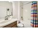 Bathroom featuring a single sink, a toilet, and a bathtub-shower combo with a colorful curtain at 8989 Cuban Palm Rd, Kissimmee, FL 34747