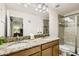 Bathroom showcasing double sinks with granite countertops, a shower, and a toilet at 8989 Cuban Palm Rd, Kissimmee, FL 34747