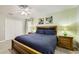 Bedroom featuring a king-size bed, wooden nightstands, and soft lighting from the lamps at 8989 Cuban Palm Rd, Kissimmee, FL 34747