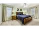 Bedroom featuring a king-size bed, wooden nightstands, and soft lighting from the lamps at 8989 Cuban Palm Rd, Kissimmee, FL 34747