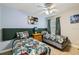 Bright bedroom with two twin beds, ceiling fan, and a large window with curtains at 8989 Cuban Palm Rd, Kissimmee, FL 34747