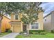 Charming two-story home with a well-maintained front yard, attached garage, and inviting curb appeal in a Gathering-friendly community at 8989 Cuban Palm Rd, Kissimmee, FL 34747
