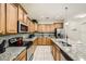 Bright kitchen featuring modern appliances, granite countertops, and ample cabinet space at 8989 Cuban Palm Rd, Kissimmee, FL 34747