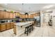 Open kitchen boasts stainless steel appliances, a center island, granite counters, and bright lighting at 8989 Cuban Palm Rd, Kissimmee, FL 34747