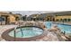 Resort-style pool area with a hot tub, waterfall feature, and comfortable lounge chairs at 8989 Cuban Palm Rd, Kissimmee, FL 34747