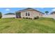 Spacious backyard with a lawn, white fence, and screened-in porch at 9262 Sw 58Th Cir, Ocala, FL 34476