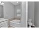 Well-lit bathroom featuring a soaking tub and a separate toilet room for added privacy at 9262 Sw 58Th Cir, Ocala, FL 34476