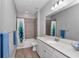 Bathroom featuring quartz countertops, a white vanity, and a shower/tub combo with decorative blue shower curtain at 9262 Sw 58Th Cir, Ocala, FL 34476