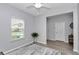 A simple bedroom with natural light, light grey walls, light grey carpet, and a view to the outside at 9262 Sw 58Th Cir, Ocala, FL 34476