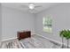 A simple bedroom with natural light, light grey walls and space for a chest and houseplant at 9262 Sw 58Th Cir, Ocala, FL 34476