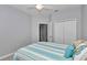 Bedroom featuring a light ceiling fan, neutral paint, and a bed with blue and white striped bedding at 9262 Sw 58Th Cir, Ocala, FL 34476
