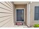 Close-up of the front door showcasing its design, sidelight, and a welcoming doormat at 9262 Sw 58Th Cir, Ocala, FL 34476