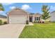 Inviting front exterior with a well-maintained lawn and mature landscaping, showcasing the home's curb appeal at 9262 Sw 58Th Cir, Ocala, FL 34476