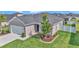 Charming front exterior of the home featuring a two-car garage, manicured lawn, and attractive landscaping at 9262 Sw 58Th Cir, Ocala, FL 34476