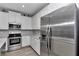 Kitchen featuring stainless steel refrigerator, oven, and microwave with ample white cabinet space at 9262 Sw 58Th Cir, Ocala, FL 34476