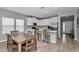 Kitchen featuring white cabinets, island seating, stainless appliances, and dining table near the window at 9262 Sw 58Th Cir, Ocala, FL 34476