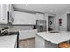 Bright kitchen featuring stainless steel appliances, white cabinets, and a center island with quartz countertops at 9262 Sw 58Th Cir, Ocala, FL 34476