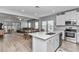 Open kitchen with stainless appliances, white cabinets, and a view into the dining and living areas at 9262 Sw 58Th Cir, Ocala, FL 34476