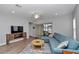 A cozy living room offers a large sectional sofa, ceiling fan, and sliding glass doors to the outdoor space at 9262 Sw 58Th Cir, Ocala, FL 34476