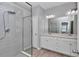 A luxurious main bathroom features double sinks, elegant white vanities, and a glass enclosed shower at 9262 Sw 58Th Cir, Ocala, FL 34476