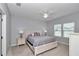 Inviting main bedroom featuring neutral walls, ceiling fan, and plenty of natural light from two windows at 9262 Sw 58Th Cir, Ocala, FL 34476