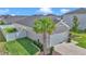Side view of the home showing a palm tree, a well-kept lawn, and a fenced yard at 9262 Sw 58Th Cir, Ocala, FL 34476