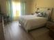 Serene main bedroom with light wood floors, ample sunlight, and calm décor at 1185 Sabine Ln, Kissimmee, FL 34759