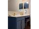 Bathroom featuring a modern vanity with gold fixtures, a stool, and a large mirror at 1009 Ronlin St, Haines City, FL 33844