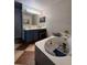 Bright bathroom features a bathtub with caddy, large mirror, and sleek vanity at 1009 Ronlin St, Haines City, FL 33844