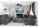 Cozy living room with neutral paint, decorative ceiling fan and gray furnishings at 1009 Ronlin St, Haines City, FL 33844
