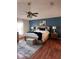 Comfortable main bedroom featuring a wood floor, a ceiling fan, and neutral paint at 1009 Ronlin St, Haines City, FL 33844