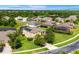 Aerial view of the house showing the backyard, the screen enclosed pool, solar panels and surrounding neighborhood at 10160 Mallard Landings Way, Orlando, FL 32832