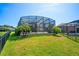 A large, green lawn surrounding the screened-in patio, offering a great view of the backyard at 10160 Mallard Landings Way, Orlando, FL 32832