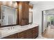 Double vanity bathroom with marble countertops and dark wood cabinets at 10160 Mallard Landings Way, Orlando, FL 32832