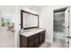 Stylish bathroom features a double sink vanity with dark wood cabinets and a separate shower at 10160 Mallard Landings Way, Orlando, FL 32832