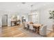 Open dining room with stylish furniture, wooden floors, and a view of the entryway and living spaces at 10160 Mallard Landings Way, Orlando, FL 32832