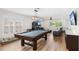 Bright game room showcases a pool table, arcade machine, modern lighting, and comfortable seating area at 10160 Mallard Landings Way, Orlando, FL 32832