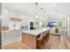 Open-concept kitchen featuring a large island with seating, stainless steel appliances, and modern design at 10160 Mallard Landings Way, Orlando, FL 32832