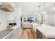 Modern kitchen with a large island, stainless steel appliances, and adjacent living room at 10160 Mallard Landings Way, Orlando, FL 32832