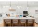 Modern kitchen features a large island with seating, stainless steel appliances, and ample cabinet space at 10160 Mallard Landings Way, Orlando, FL 32832