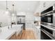 Stunning kitchen with stainless steel appliances, an island with seating, and white cabinets at 10160 Mallard Landings Way, Orlando, FL 32832