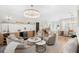 Inviting living room with elegant furniture, wooden floors, and open access to other living spaces at 10160 Mallard Landings Way, Orlando, FL 32832