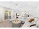 Bright living room features an oversized sectional and a view to the kitchen and dining area at 10160 Mallard Landings Way, Orlando, FL 32832