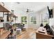 Cozy living room features light wood floors, modern furniture, and bright, natural light streaming through shuttered windows at 10160 Mallard Landings Way, Orlando, FL 32832