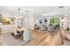 Open-concept living space with dining area, cozy seating, and access to outdoor views through large windows at 10160 Mallard Landings Way, Orlando, FL 32832
