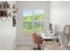 Cozy, minimalist home office featuring a desk, chair, and natural light from a shuttered window at 10160 Mallard Landings Way, Orlando, FL 32832