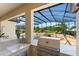 Outdoor kitchen with granite countertops, a sink, and a stainless steel grill at 10160 Mallard Landings Way, Orlando, FL 32832