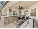 Covered patio featuring a stone bar, comfortable seating, and a ceiling fan at 10160 Mallard Landings Way, Orlando, FL 32832